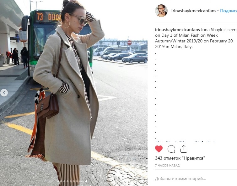 Элегантное пальто и полосатый комбинезон: Ирина Шейк прилетела на Неделю моды в Милан